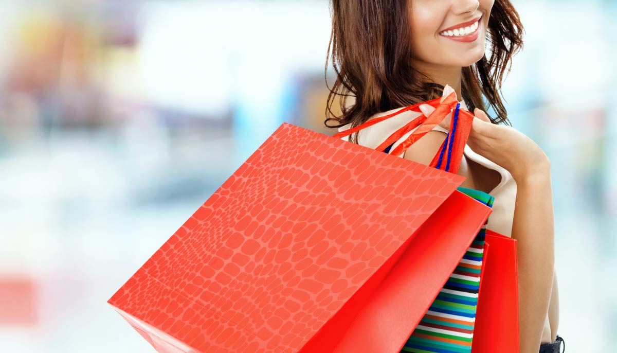 Treat Yourself: Smiling woman with shopping bags